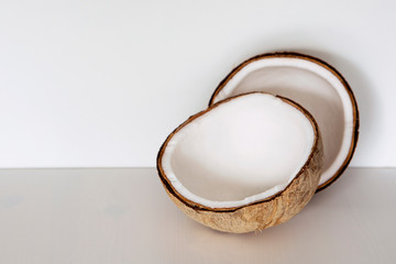 Fresh coconut on white background with copy space. Nut cut in half, exotic background.