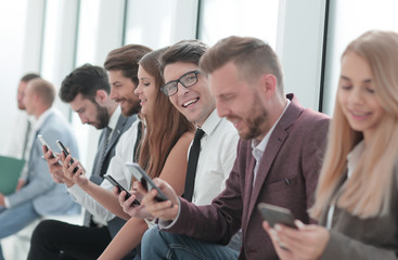 group of diverse young people sitting in the office lobby