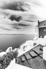 Santorini Greece process in dramatic black and white. Beautiful artistic image of Santorini white architecture as beautiful travel landscape.