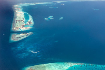Amazing aerial of the beautiful atolls of the Maldives. Small tropical island in Maldives atoll from aerial view