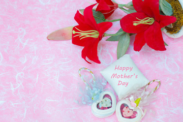 Happy Mother's day concepts. Mother's day and Sweetest day, love concept. Red flower with the letter Happy Mother's day on white pillow. copy space for text.