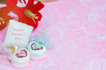 Happy Mother's day concepts. Mother's day and Sweetest day, love concept. Red flower with the letter Happy Mother's day on white pillow. copy space for text.