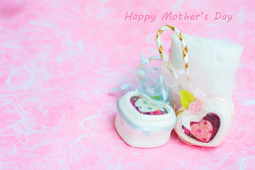 Happy Mother's day concepts. Mother's day and Sweetest day, love concept. White heart boxes with the letter Happy Mother's day on pink paper. copy space for text.