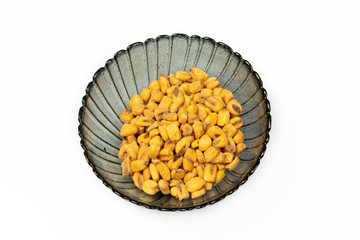 Roasted corn nuts in plate on white background