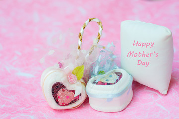 Obraz na płótnie Canvas Happy Mother's day concepts. Mother's day and Sweetest day, love concept. White heart boxes with the letter Happy Mother's day on white pillow. copy space for text.