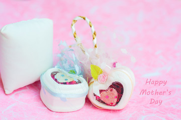 Happy Mother's day concepts. Mother's day and Sweetest day, love concept. White heart boxes with the letter Happy Mother's day on pink paper. copy space for text.