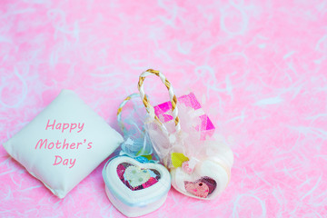 Happy Mother's day concepts. Mother's day and Sweetest day, love concept. White heart boxes with the letter Happy Mother's day on white pillow. copy space for text.