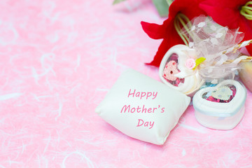 Happy Mother's day concepts. Mother's day and Sweetest day, love concept. Red flower with the letter Happy Mother's day on white pillow. copy space for text.