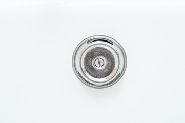 Clean shiny lid of the bathtub’s tap hole.