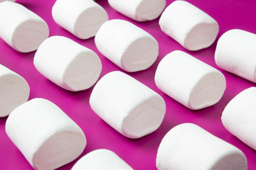 White marshmellow close up on pink background
