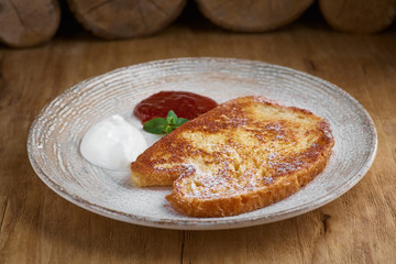 French toasted slices bread and maple syrup. Toasted breads on the plate for breakfast
