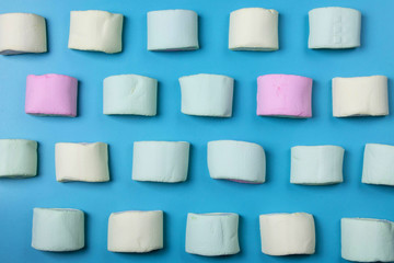 Multicolored marshmallows on a blue background