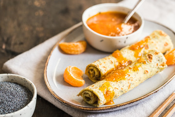 poppy seed crepes (blinis). pancakes with poppy seeds and tangerine jam