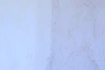 Putty wall aligning with plaster in room, renovation construction works and overhaul, closeup view. Finishing repairing works. Texture of gray cement wet plaster and dry white wall.