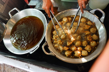 fried tofu in a frying pan with boiling oil