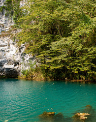 Unique blue mountain lake of the Caucasus located in a gorge with clear water and a depth of more than 100 meters