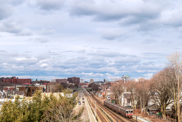 View of railway tracks, trains and downtown in the distance in Quincy, Massachusetts