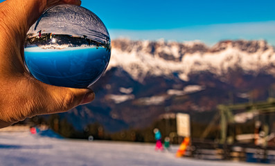 Crystal ball in my hand alpine landscape shot at the famous Rossfeldstrasse near Berchtesgaden, Bavaria, Germany