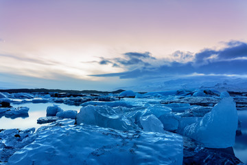 Cold iceland glacier jokulsarlon in the evening icebergs floating on the cold peaceful water after sunset