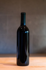 Unlabeled wine bottle on wooden table - Winery