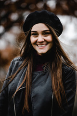 Happy beautiful girl having fun walking outdoor. Portrait of young smiling woman in beret. Lovely girl posing in the old street. Joint vacation concept