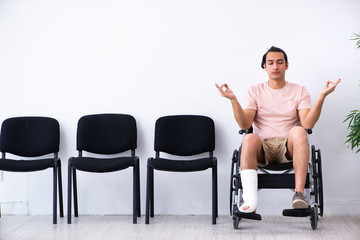 Young injured man waiting for his turn in hospital hall
