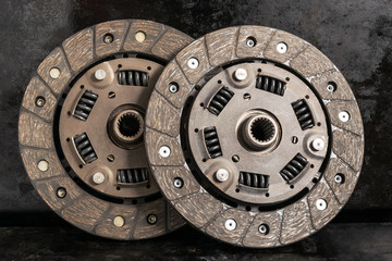 Two clutch discs on a dark background.