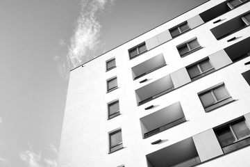Detail of modern residential flat apartment building exterior. Fragment of new luxury house and home complex. Black and white.