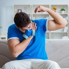 Man sweating excessively smelling bad at home
