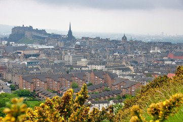 Cityscape of the City of Edinburgh and its famous Castle on a typical foggy summer afternoon