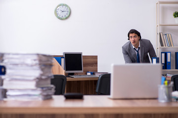 Fototapeta na wymiar Young male employee unhappy with excessive work