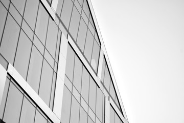 Fototapeta na wymiar Abstract modern architecture with high contrast black and white tone. Architecture of geometry at glass window - monochrome.