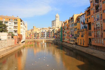 The amazing colorful houses along the river Onyar and the Cathedral of Saint Mary in the gorgeous city of Girona, Catalonia, Spain.