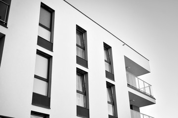 Detail of modern residential flat apartment building exterior. Fragment of new luxury house and home complex. Black and white.