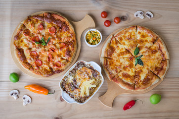 Italian pizza and pasta served in the wooden table