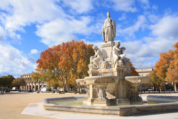 Fototapeta na wymiar The amazing arena and Pradier fountain in Nimes, France