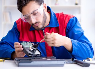 Repairman working in technical support fixing computer laptop tr