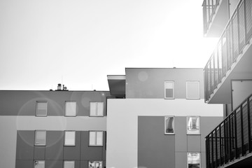 Detail of modern residential flat apartment building exterior. Fragment of new luxury house and home complex. Black and white.