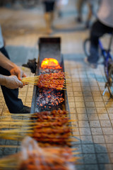 Man preparing skewers in street of Shanghai.