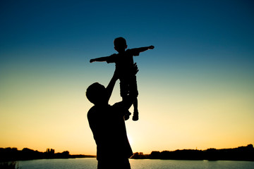 silhouette of father and son  on sunset