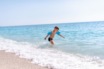 Fototapeta premium One boy is playing on the beach