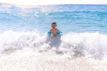One boy is playing on the beach