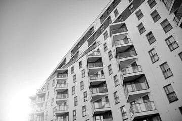 Detail of modern residential flat apartment building exterior. Fragment of new luxury house and home complex. Black and white.