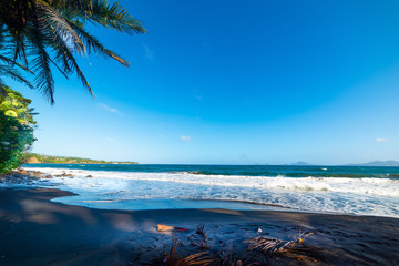 Dark sand in Grande Anse beach in Guadeloupe