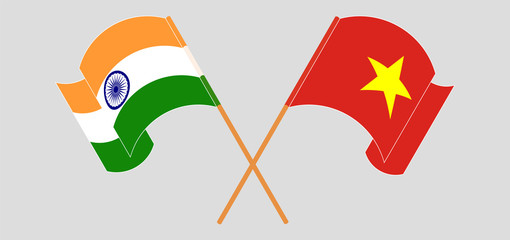 Crossed and waving flags of India and Vietnam