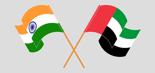 Crossed and waving flags of India and the United Arab Emirates