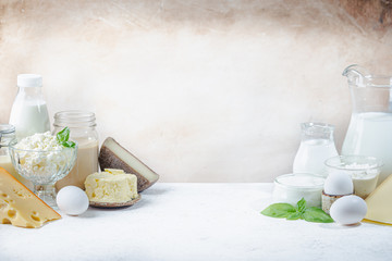 Fototapeta na wymiar Fresh dairy products, milk, cottage cheese, eggs, yogurt, sour cream and butter on white table