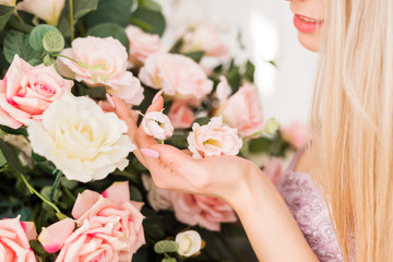 close-up of women's hands holding flowers in soft pink tones. Beautiful manicure and photos.