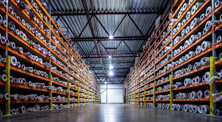 Production warehouse at the enterprise. Storage of products on large steel racks and pallets