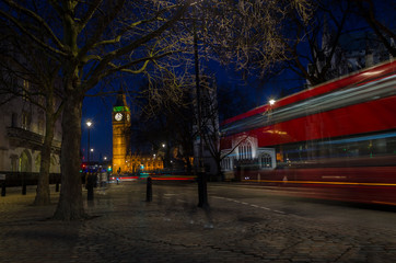 London, England, February 16th, 2017: Long exposure with red bus next to Big Ben at Night in London City
